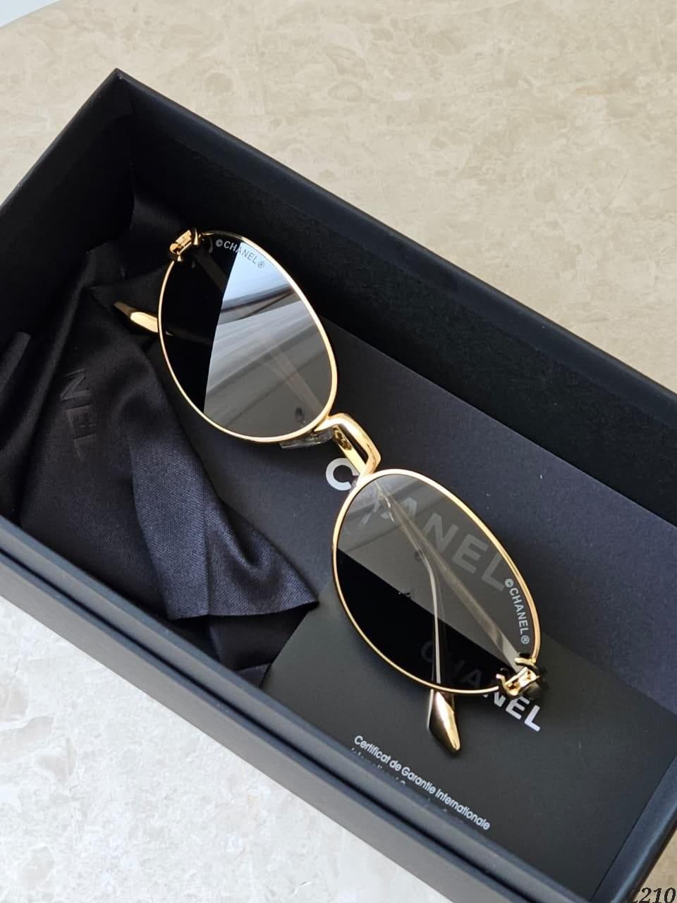 Silver oval metal sunglasses with purple lenses · 2