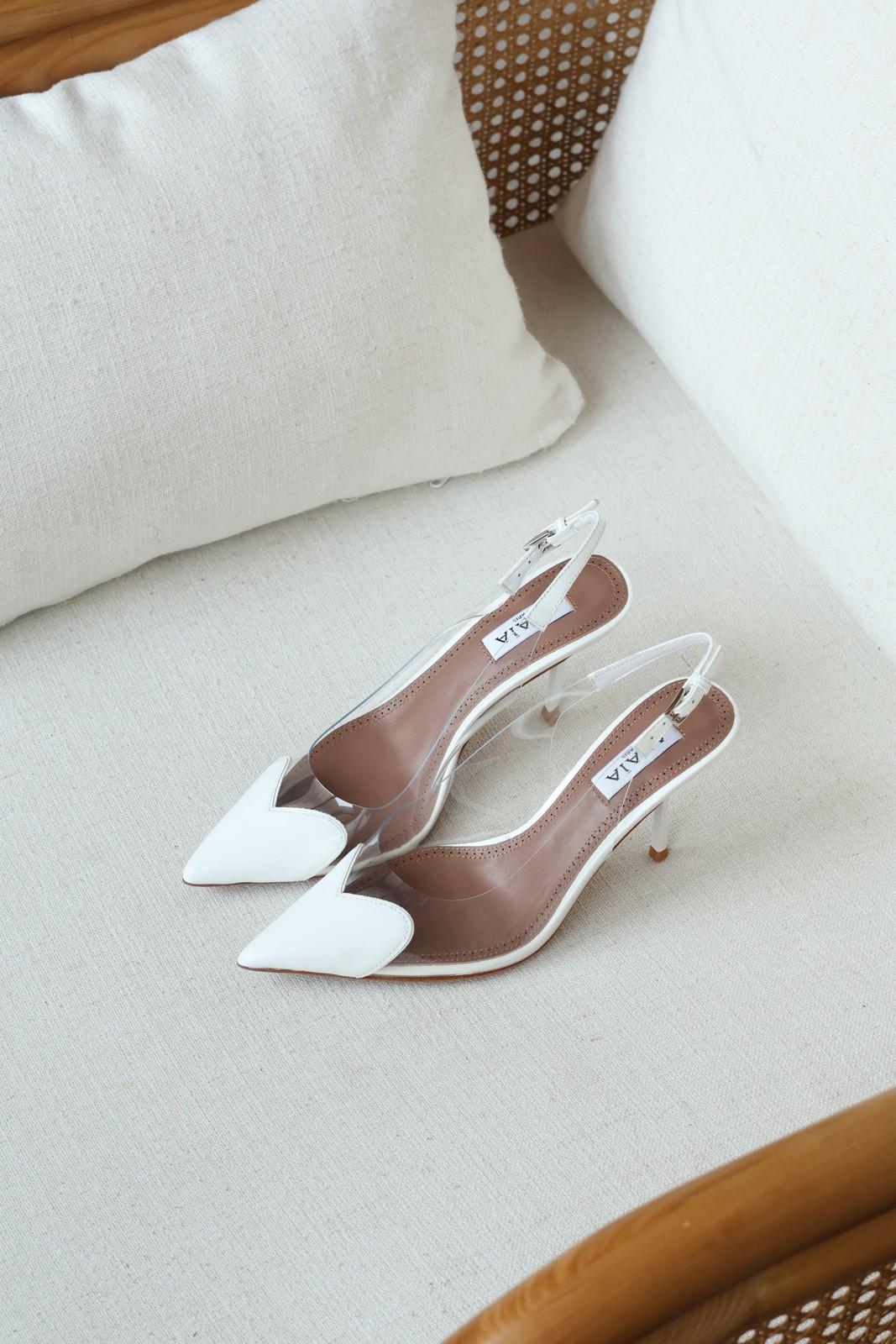 Alaia clear PVC slingback pumps with patent cap toe · 2