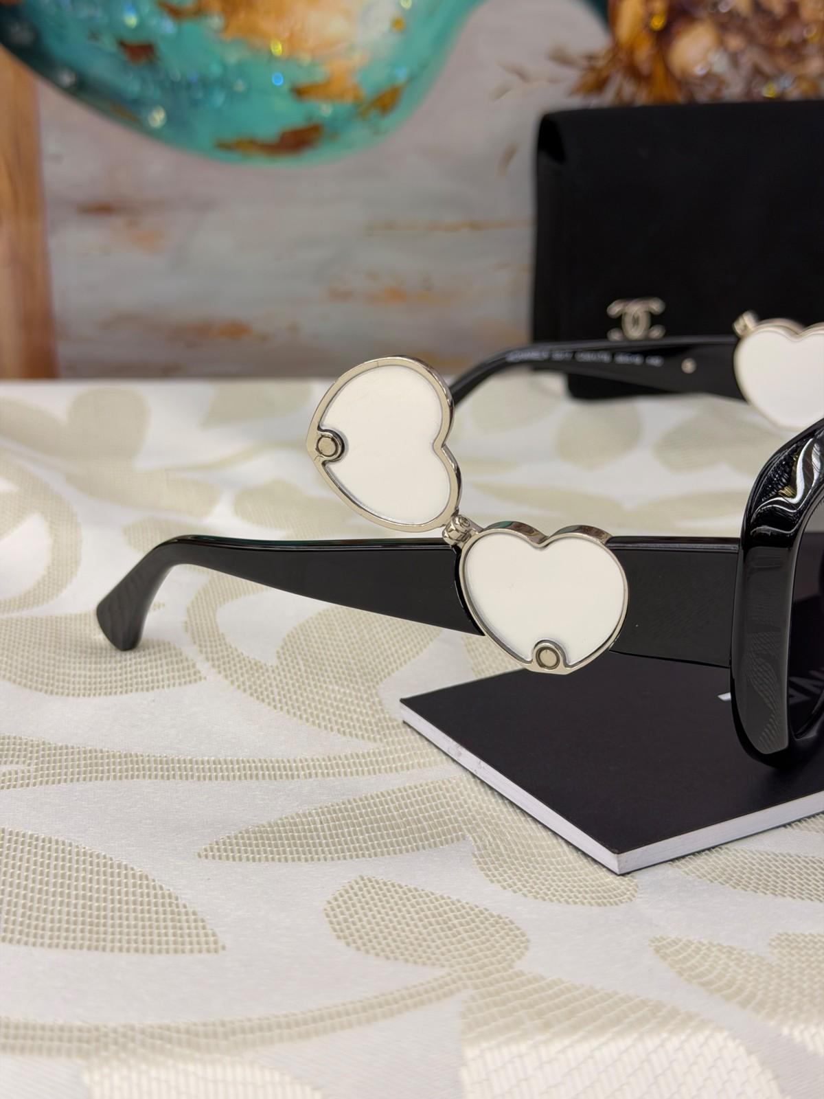 Chanel black sunglasses with heart-shaped CC temples · 2