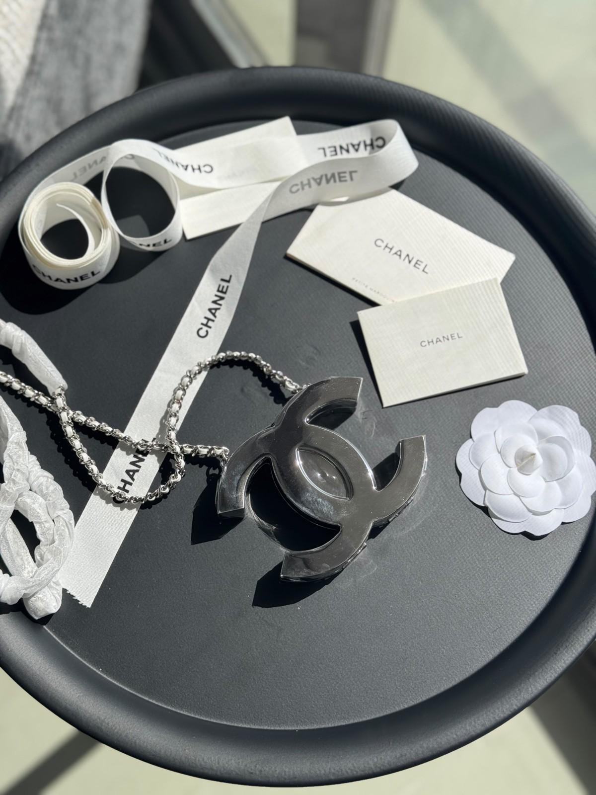 Chanel interlocking CC pendant necklace on a leather-and-chain cord · 2