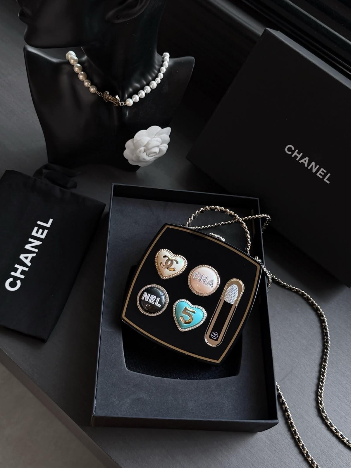 Chanel pearly white egg-shaped evening bag (folder also holds a black charm bag) · 2