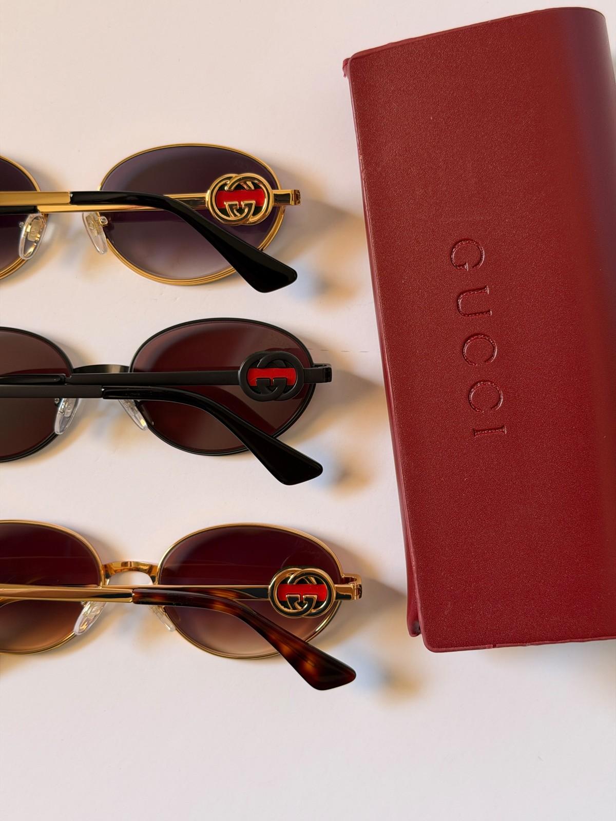 Gucci oval metal sunglasses with enamelled GG temple logo · 2