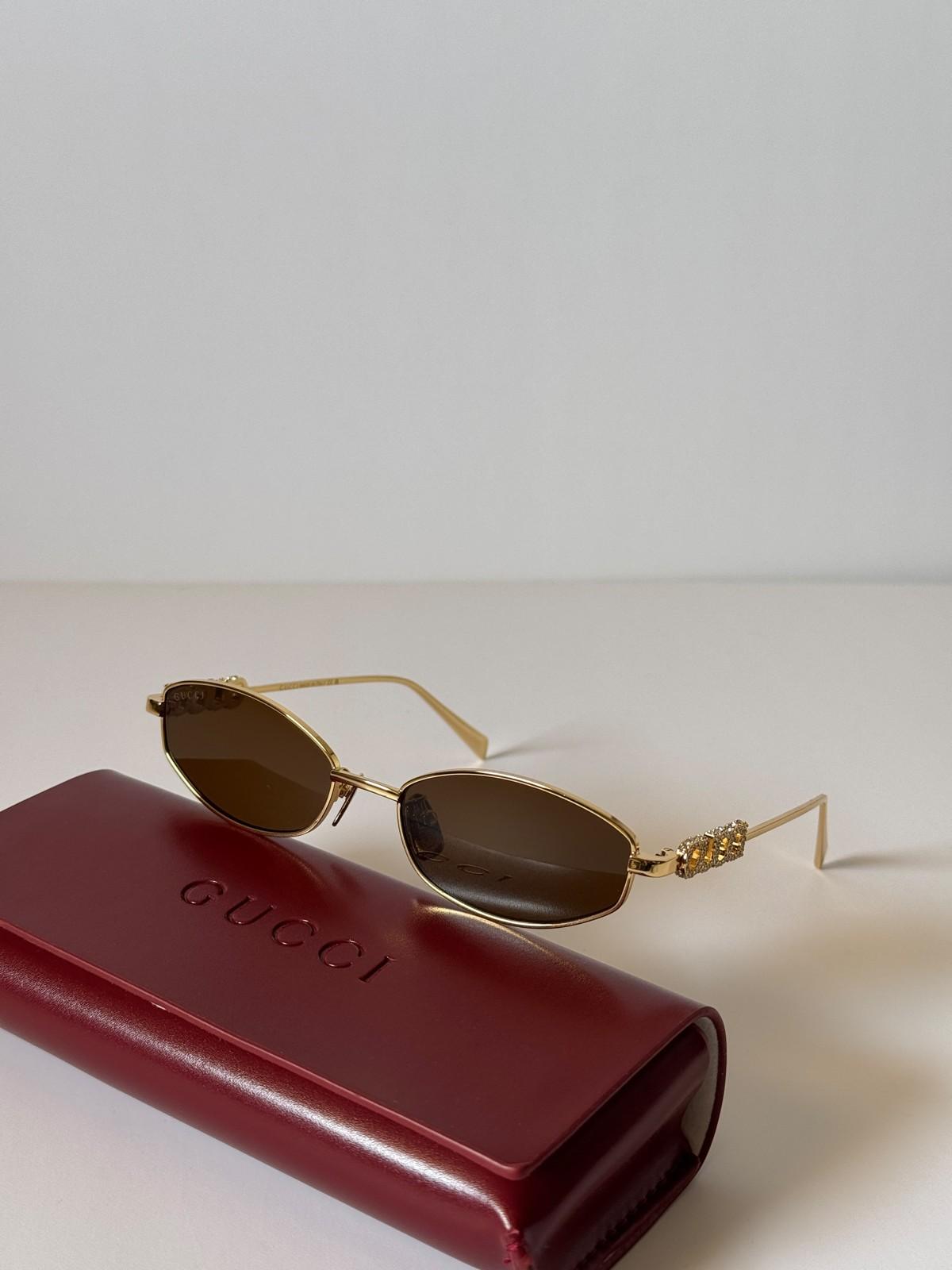 Gucci oval metal sunglasses with crystal GUCCI wordmark temples · 3
