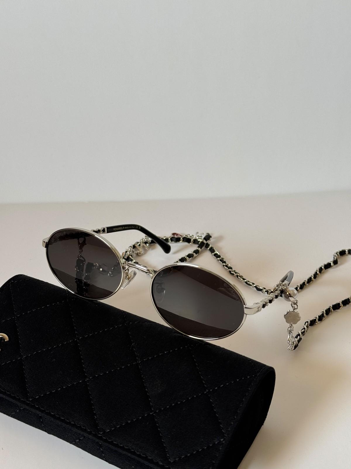 Chanel oval metal sunglasses with CC on the lens and CHANEL chain · 2