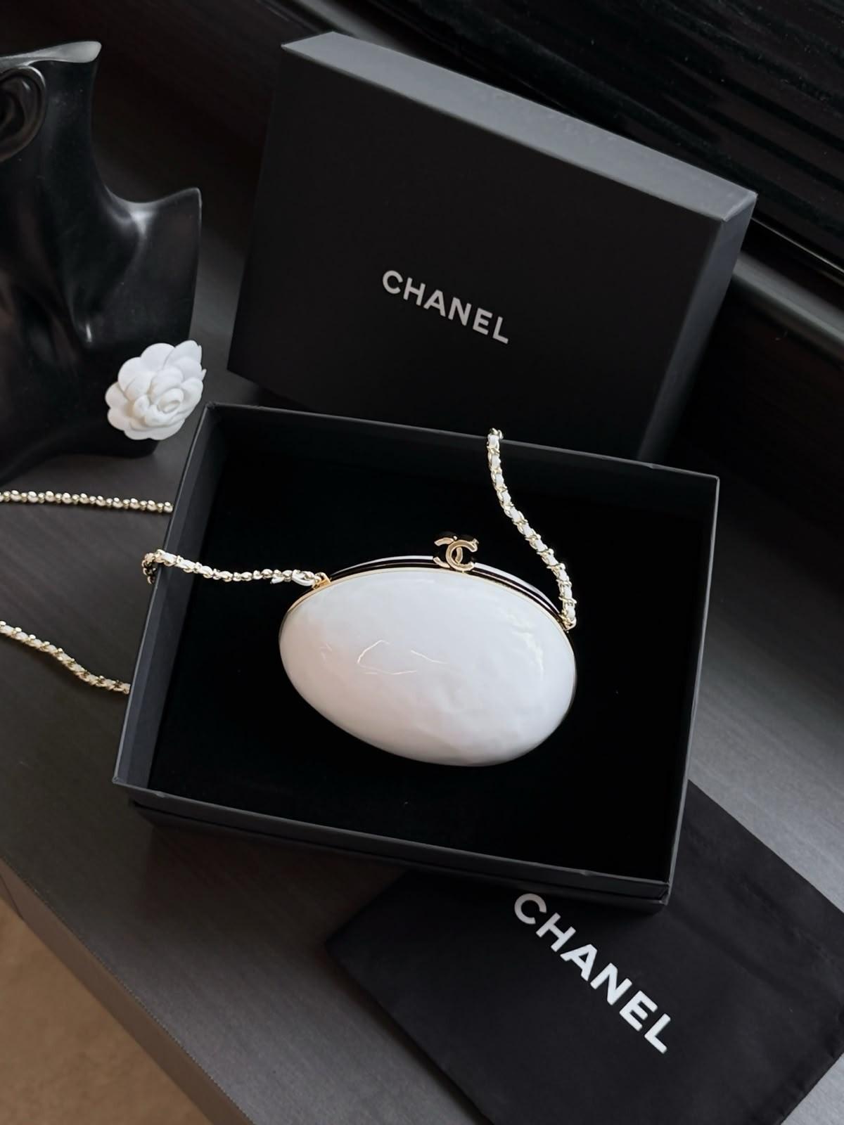 Chanel pearly white egg-shaped evening bag (folder also holds a black charm bag)